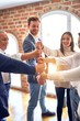 © Krakenimages.com - Group of business workers smiling happy. Standing bumping fists at the office