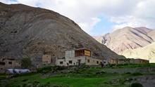 Tilt Down Shot Of A Remote Village On The Markha Valley Trek As A Single Man Arrives At The End Of A Long Journey. 