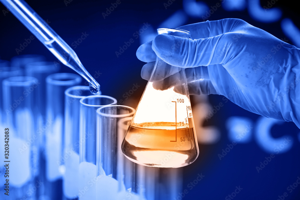 Flask in scientist hand with lab glassware background - obrazy, fototapety, plakaty 