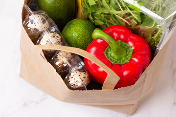 Wall Mural - organic fruits, vegetables and eggs in a paper bag close-up