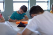 © wavebreak3 - Schoolboy writing during a lesson in an elementary school classroom