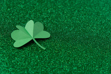 St. Patrick's day, clover on a green shiny background