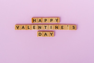 Wall Mural - Happy Valentine's Day text wood blocks. Pink background.