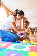 © Krakenimages.com - Beautiful toddler boy sitting on puzzle playing with plastic plates, fruits and vegetables at kindergarten