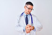 Young Doctor Man Wearing Stethoscope Over Isolated Background Checking The Time On Wrist Watch, Relaxed And Confident