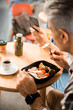 © Yakobchuk Olena - Top view of male having lunch in cafe