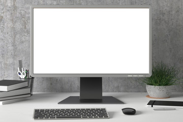 Workspace with blank computer monitor white screen mock up on the white desk near concrete wall. monitor; screen; computer; mock up;