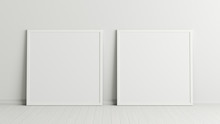 Two Blank Square Posters. Frame Mock Up Standing On White Floor Next To White Wall. Clipping Path Around Posters. 3d Illustration