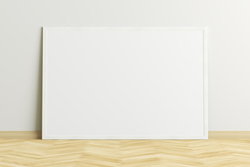 Poster - Blank horizontal poster frame mock up standing on light herringbone parquet floor next to white wall. Clipping path around poster. 3d illustration