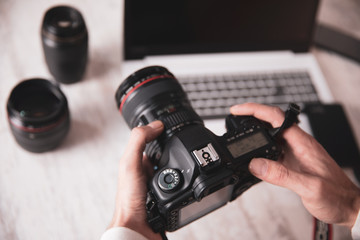 Poster - photographer man hand  camera on desk