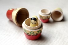 Wooden Russian Matryoshka Dolls In Folk Style, Girls With Painted Dresses And Veiled Heads Covered With Babushka Shawl. A Little Girl Is Lost, Alone And Frightened