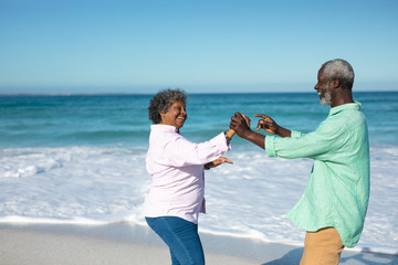 Wall Mural - Old couple having fun at the beach