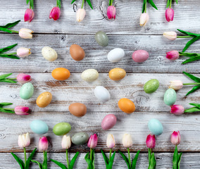 Sticker - Happy Easter holiday concept with eggs surrounded by pink tulip box shaped border on white rustic wood