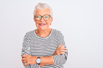 Senior grey-haired woman wearing striped navy t-shirt glasses over isolated white background happy face smiling with crossed arms looking at the camera. Positive person.