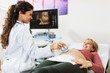 © hedgehog94 - Obstetrician examining pregnant belly by ultrasonic scan.