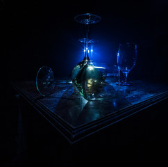 Goblet of white wine on wooden table on wooden wall background