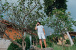 © Anna - A man in white clothes in a tropical garden