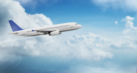 Wall Mural - Commercial airplane jetliner flying above dramatic clouds in beautiful light. Travel concept.