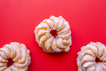 Wall Mural - Honey Cruller Donuts on a Red Background
