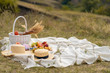 © Kate - Stylish summer picnic on a white blanket. In a picturesque place the nature of the hills.