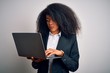 © Krakenimages.com - Young african american business woman with afro hair using computer laptop from job with a confident expression on smart face thinking serious