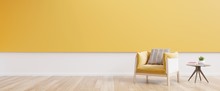 Living Room Interior With Yellow Fabric Armchair,book And Plants On Empty Yellow Wall Background.