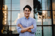 © blacksalmon - Happy Young Businessman Standing with a Big Smile in the City. Crossed Arms and Looking at Camera