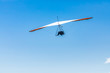 © Valmedia - Extremal air sports competition - Hang gliding. Overhead view of the soaring hang gliding pilot against the clear blue sky