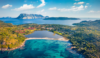Wall Mural - View from flying drone. Breathtaking spring scene of Salina Bamba beach with Tavolara mountain on background. Captivating morning view of Sardinia island, Italy, Europe. .