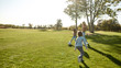 © Svitlana - Affordable family fun. Happy family playing with a ball on meadow