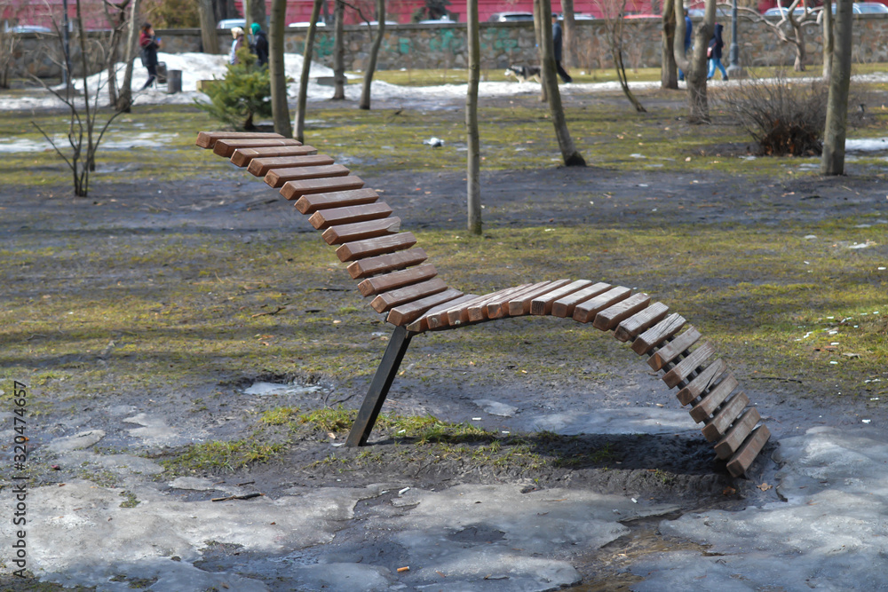 Bench in park of Taras Shevchenko in Kyiv, Ukraine on April 1, 2018.  - obrazy, fototapety, plakaty 