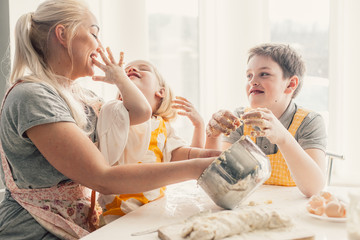 Wall Mural - Mom cooking with kids on the kitchen