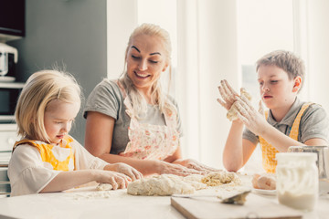 Wall Mural - Mom cooking with kids on the kitchen