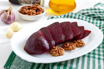 Wall Mural - Slices of boiled beets on a white plate. Source of energy. Dietary healthy vegetable.