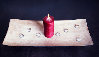 Wall Mural - Decoration: a red candle on a placemat with glass hearts.