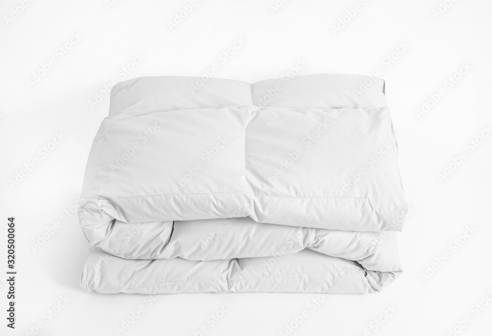 Folded soft white duvet, blanket or bedspread, against white background. Close up photo - obrazy, fototapety, plakaty 