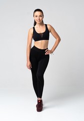 Young fit woman in sports outfit, studio photo.