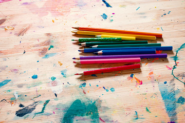 Colorful Pencils on Wodden Background with Brush Stains. Backdrop for Creative Designers.