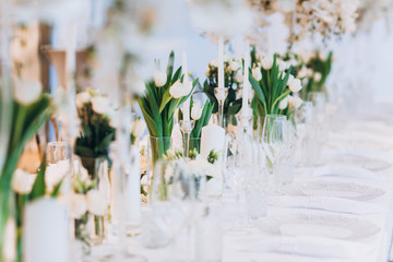 formal luxury elegant wedding decor restaurant tables served white tablecloth, plates, menus, glasse