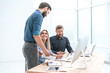 © yurolaitsalbert - business team discussing working documents in a light office.