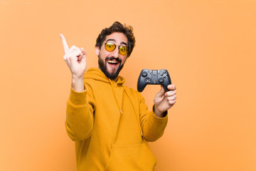 Wall Mural - young crazy cool man paying with a game console controller