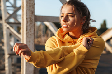 Sports fitness woman make stretching exercises outdoors.