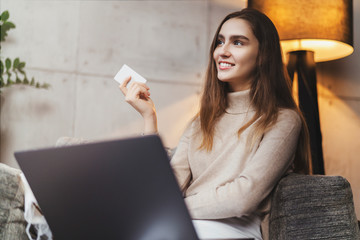 Girl using bank card for buying things online. Retail stores offering bonus cards for customers. Select items in web shop app, transfer money safely using sms code for payment. Money refund guarantee.