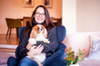 © sepy - Happy young woman with her cute puppy at home