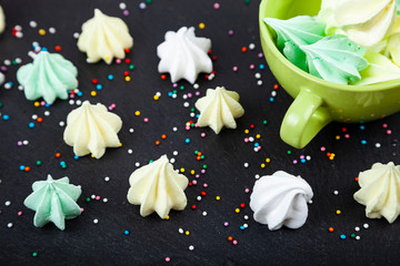 Meringue in a green cup on a dark background