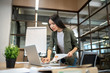 © zinkevych - Long-haired brunette asian girl dealing with documents and looking involved