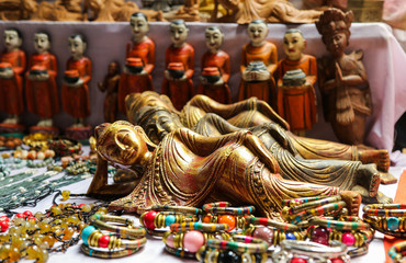 Wall Mural - A lot of bright souvenirs on the counter of the ancient souvenir market in Myanmar