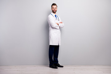 Poster - Full length body size profile side half-turned view of nice attractive cheerful content doc first aid medicare medico assistance center folded arms isolated on light white gray pastel color background