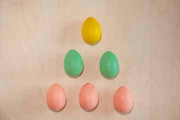 Colorful easter eggs on wooden background