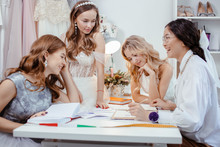 Group Caucasian Models Have Conversation With Designer And Tailor Of Wedding Dresses, Have Friendly Conversation And Consultation Or Advice: Which Style And Type Of Dress Is Appropriate And For Whom